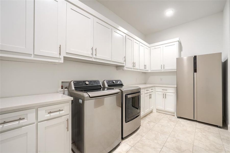 Laundry room featuring washer and dryer and cabinet space