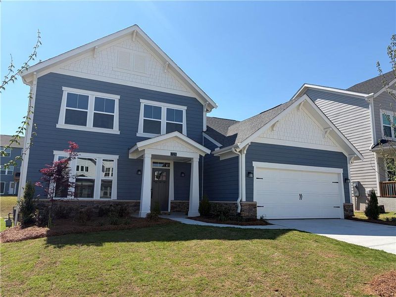 Front exterior of a new home in Twin Lakes, Hoschton, GA, highlighting curb appeal (Image 1). Front exterior of a new home in Twin Lakes, Hoschton, GA, highlighting curb appeal (Image 1).