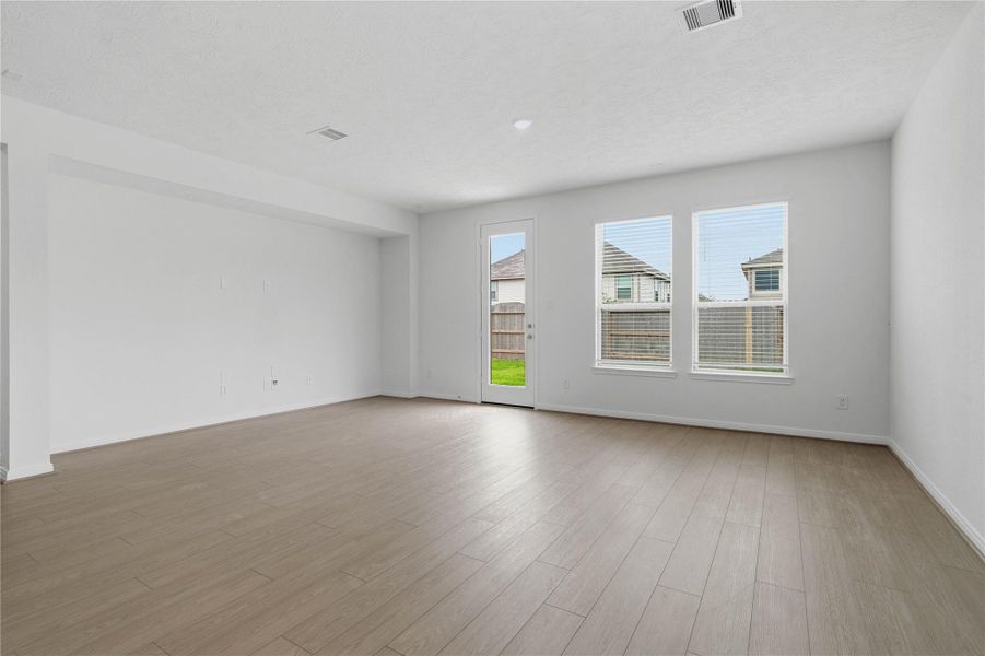 This spacious family room features a dedicated wall niche, perfectly designed for a custom entertainment center or built-in shelving. This architectural detail adds both depth and character to the open-concept living area. This spacious family room features a dedicated wall niche, perfectly designed for a custom entertainment center or built-in shelving. This architectural detail adds both depth and character to the open-concept living area.