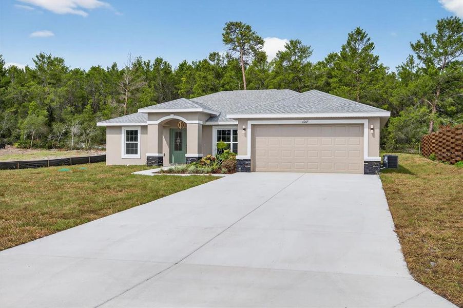 Front exterior of a new home in , Spring Hill, FL, highlighting curb appeal (Image 2).