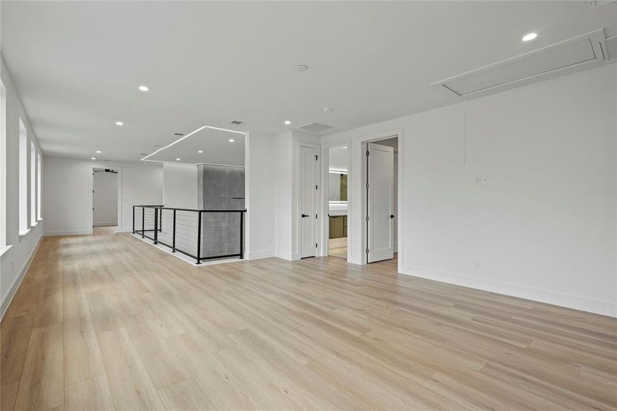 Unfurnished room with attic access, recessed lighting, and light wood-type flooring