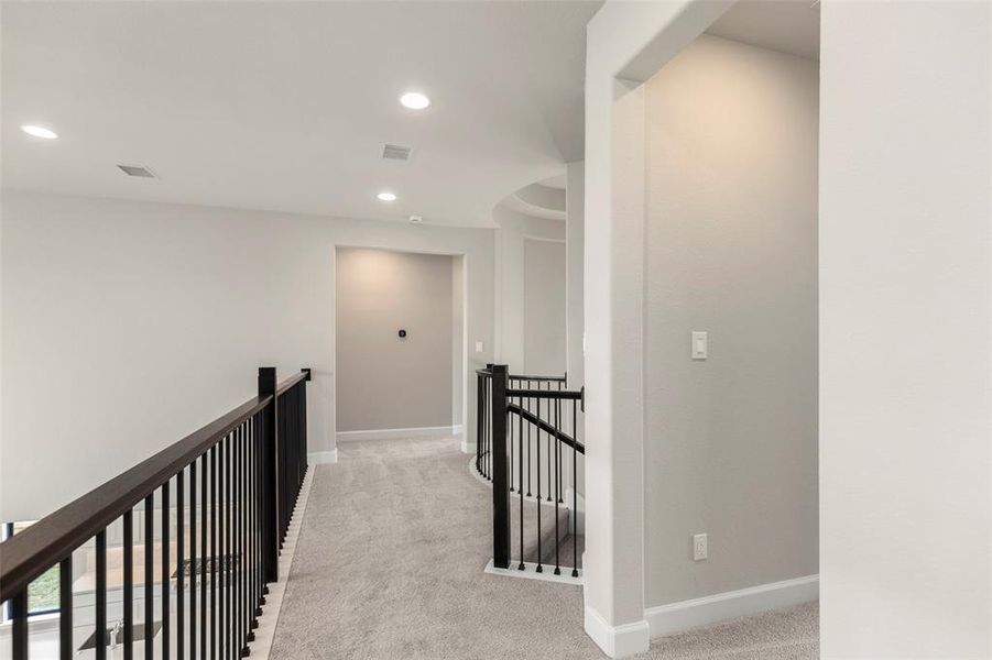 Top of the Stairs with a View and Access to Three Bedrooms Upstairs, a Game Room, and a Media Room