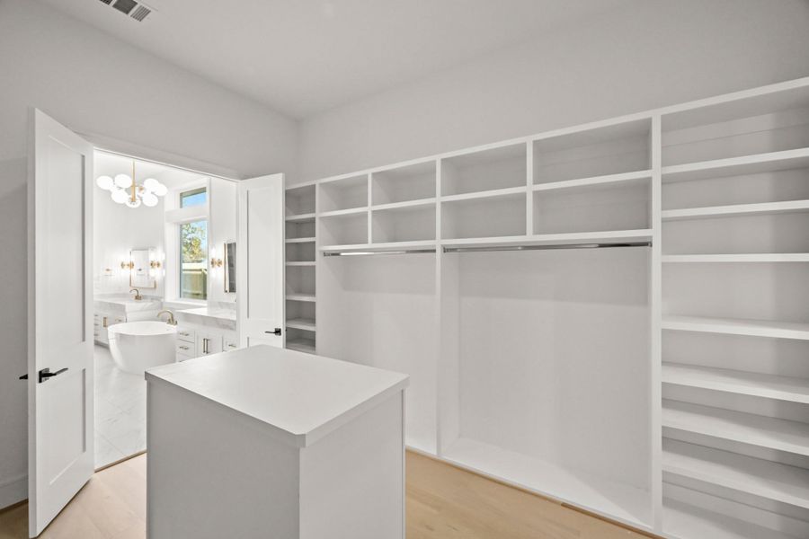 Back in the master closet, you've got tons of room for shoes and bags!