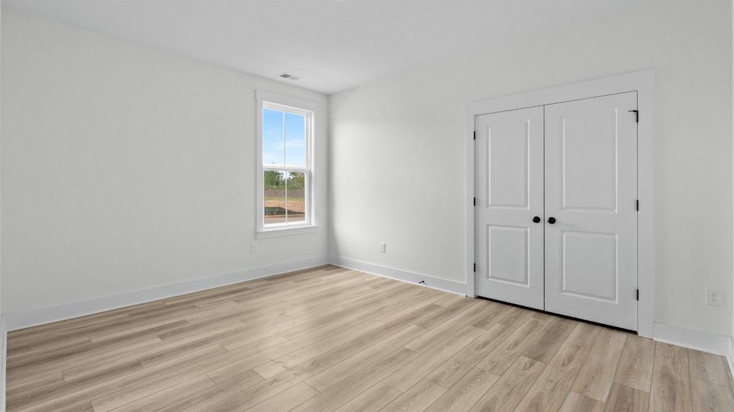 Spacious secondary bedroom with closet at Chestnut Farms by DRB Homes