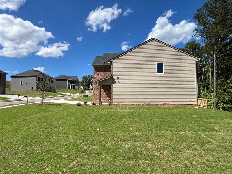Front exterior of a new home in River Walk Farm, Covington, GA, highlighting curb appeal (Image 19). Front exterior of a new home in River Walk Farm, Covington, GA, highlighting curb appeal (Image 19).
