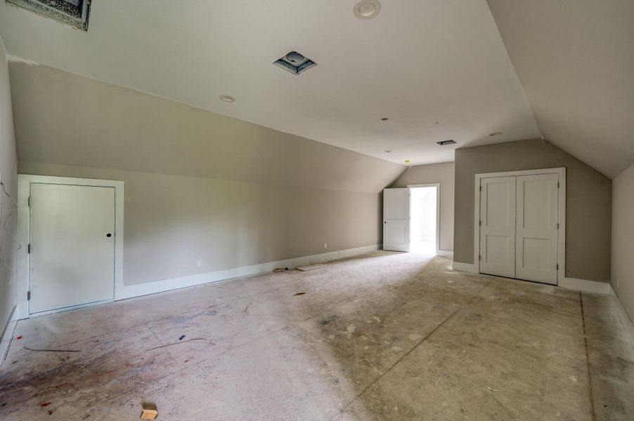 This is the upstairs gameroom with a full bathroom and bedroom. Perfect for guests or gym since it's above the garage.