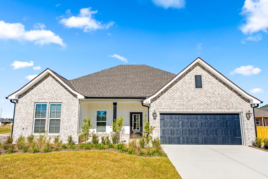 Front exterior of a new home in Natureview, Freeport, FL, highlighting curb appeal (Image 1).
