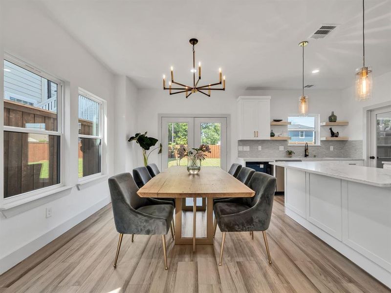 Dining area featuring a chandelier, light wood-type flooring, and recessed lighting Dining area featuring a chandelier, light wood-type flooring, and recessed lighting