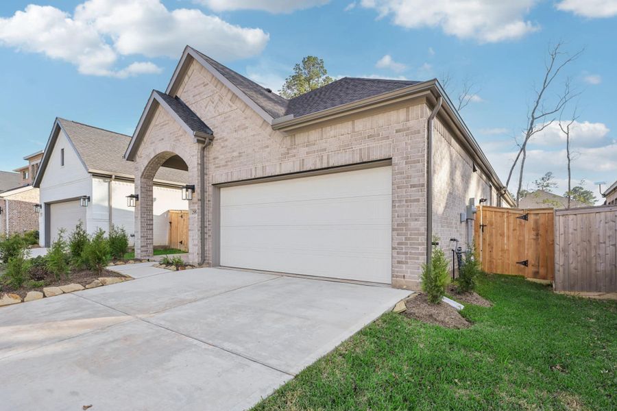 Front exterior of a new home in The Woodlands Hills, Willis, TX, highlighting curb appeal (Image 29).