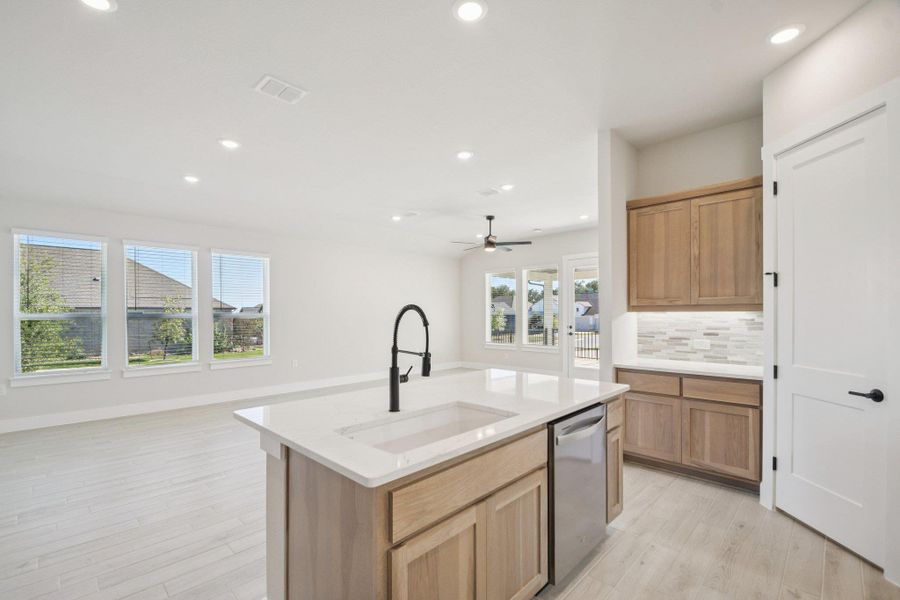 Kitchen featuring recessed lighting, dishwasher, open floor plan, and light wood finished floors