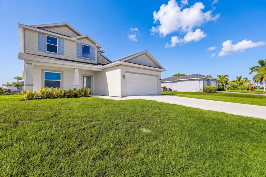 Front exterior of a new home in Cape Coral, Cape Coral, FL, highlighting curb appeal (Image 1). Front exterior of a new home in Cape Coral, Cape Coral, FL, highlighting curb appeal (Image 1).