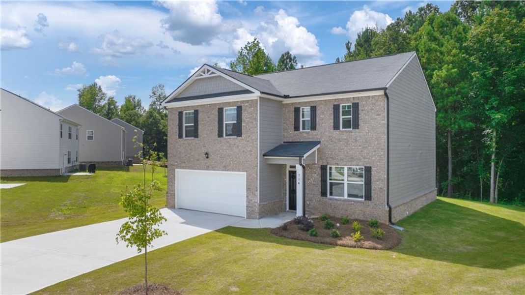 Front exterior of a new home in The Reserve at Calcutta, Stockbridge, GA, highlighting curb appeal (Image 12).