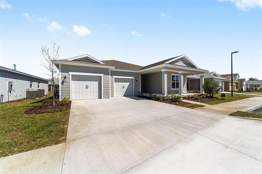 Front exterior of a new home in Calesa Township, Ocala, FL, highlighting curb appeal (Image 23). Front exterior of a new home in Calesa Township, Ocala, FL, highlighting curb appeal (Image 23).