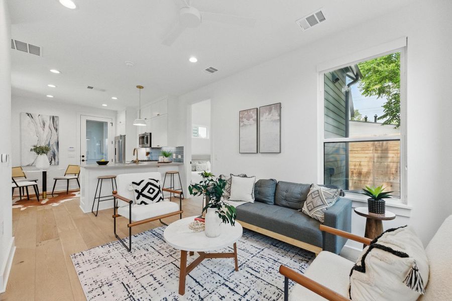 Living area featuring light wood-type flooring, recessed lighting, and ceiling fan Living area featuring light wood-type flooring, recessed lighting, and ceiling fan