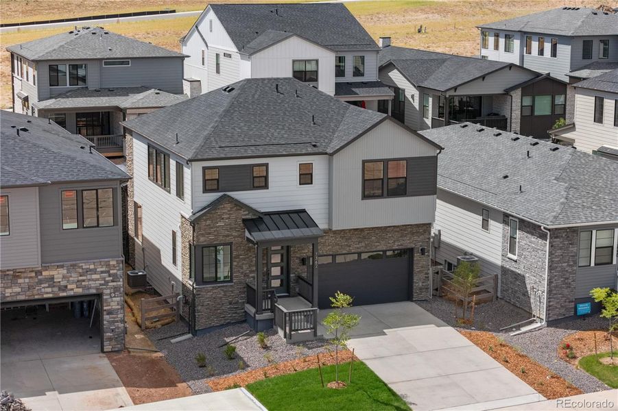 Front exterior of a new home in Harmony at Sterling Ranch, Littleton, CO, highlighting curb appeal (Image 24). Front exterior of a new home in Harmony at Sterling Ranch, Littleton, CO, highlighting curb appeal (Image 24).