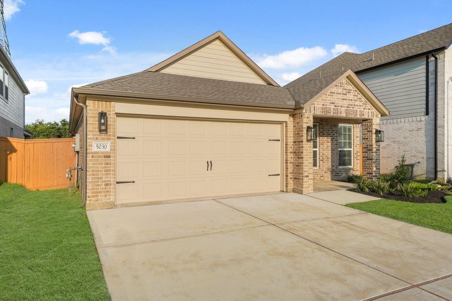 Front exterior of a new home in Sunterra North, Katy, TX, highlighting curb appeal (Image 12). Front exterior of a new home in Sunterra North, Katy, TX, highlighting curb appeal (Image 12).