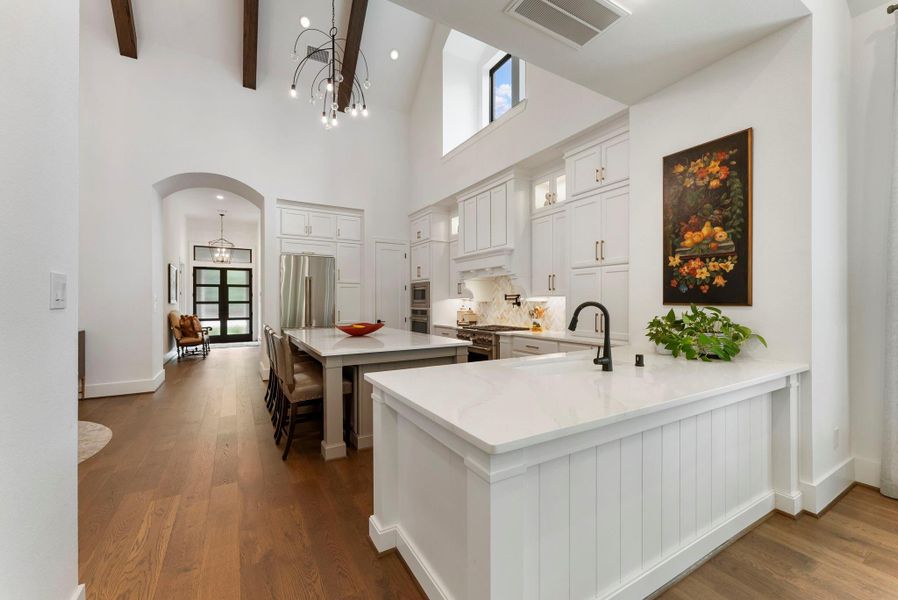 The open layout allows the kitchen, dining, and living areas to function together with ease. Thoughtful design choices improve sightlines, entertaining flow, and everyday livability.