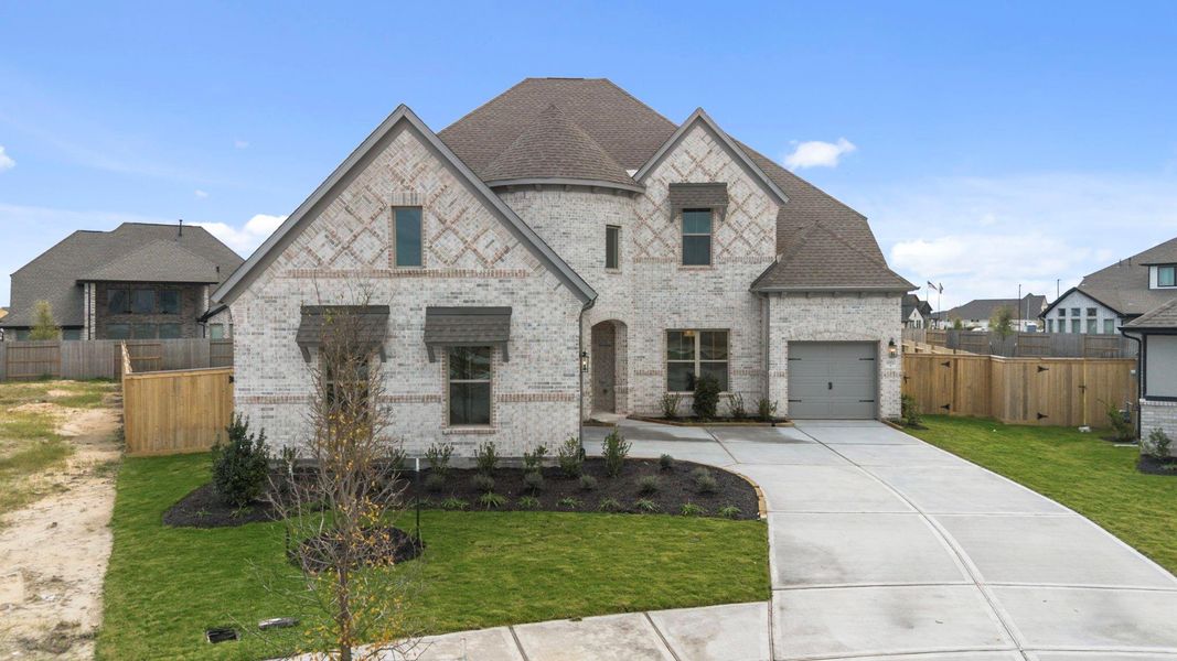 Front exterior of a new home in Valencia, Manvel, TX, highlighting curb appeal (Image 20).