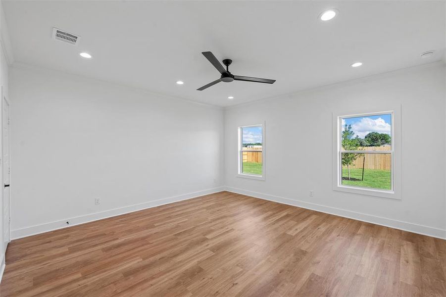 Empty room featuring crown molding, a ceiling fan, recessed lighting, and light wood finished floors