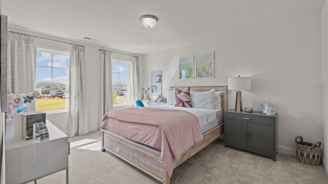 Secondary bedroom with large windows, elevated ceiling, and plush carpeting, in the Townsend Design by DRB Homes in York, SC