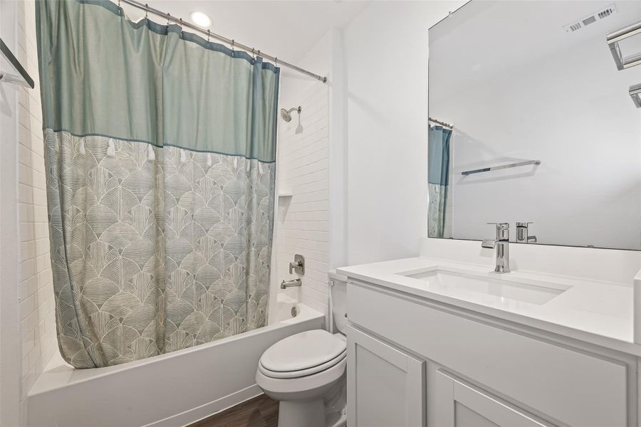 Secondary full bathroom, shower-tube combo, includes storage shelving for linen. Secondary full bathroom, shower-tube combo, includes storage shelving for linen.