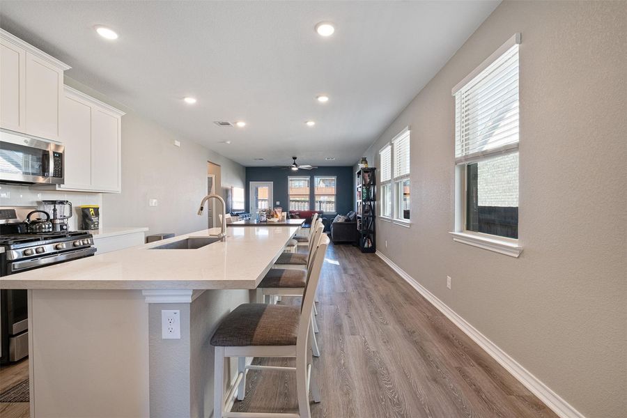 Seating area in kitchen with open floor plan to living area.