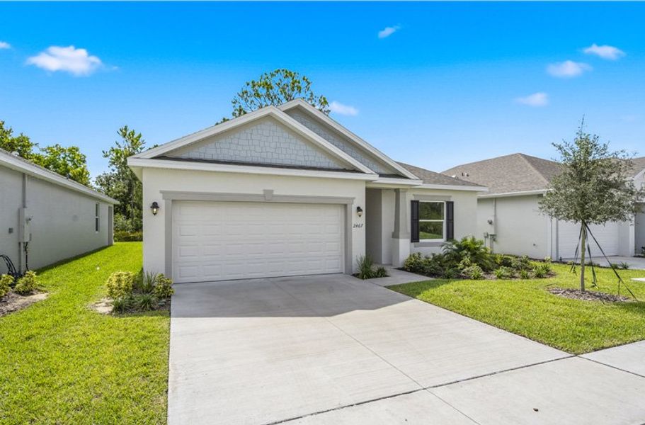 Front exterior of a new home in Huntington Park, Titusville, FL, highlighting curb appeal (Image 2). Front exterior of a new home in Huntington Park, Titusville, FL, highlighting curb appeal (Image 2).