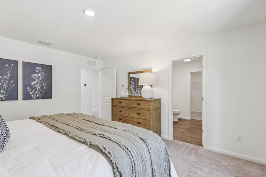 A bedroom with a bed and dresser. A bedroom with a bed and dresser.