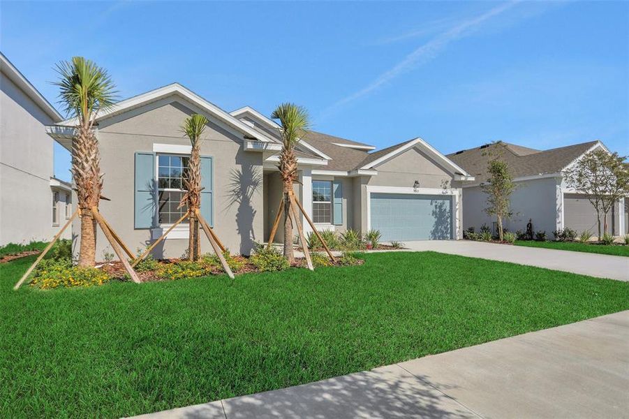 Front exterior of a new home in Angeline, Land O' Lakes, FL, highlighting curb appeal (Image 24).