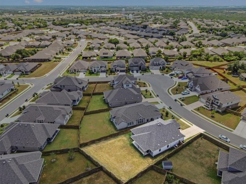 Aerial view of property and surrounding area featuring nearby suburban area Aerial view of property and surrounding area featuring nearby suburban area