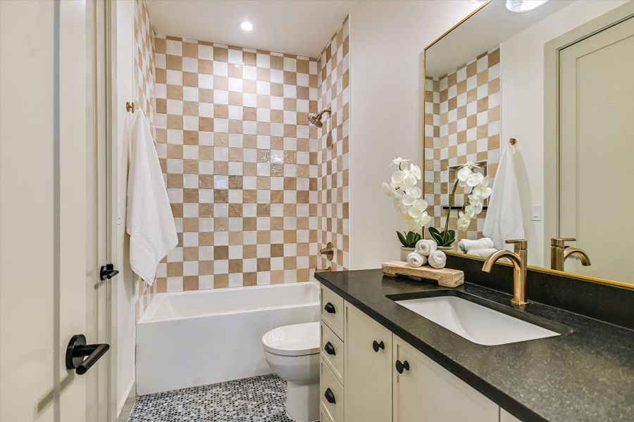 One of the two full upstairs bathrooms - featuring whimsical tilework! This bathroom also serves the lofted game room. One of the two full upstairs bathrooms - featuring whimsical tilework! This bathroom also serves the lofted game room.