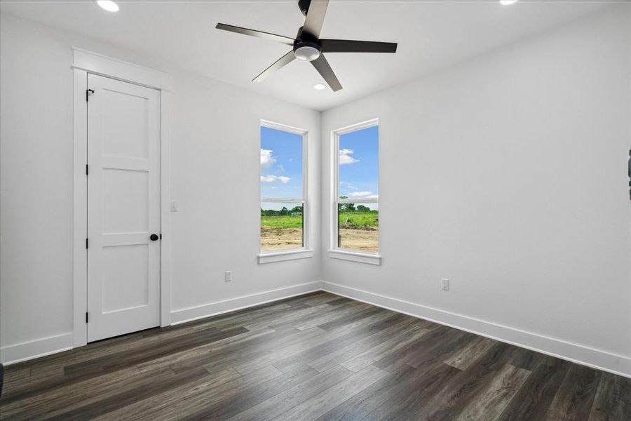 Spare room with ceiling fan, recessed lighting, and dark wood-type flooring