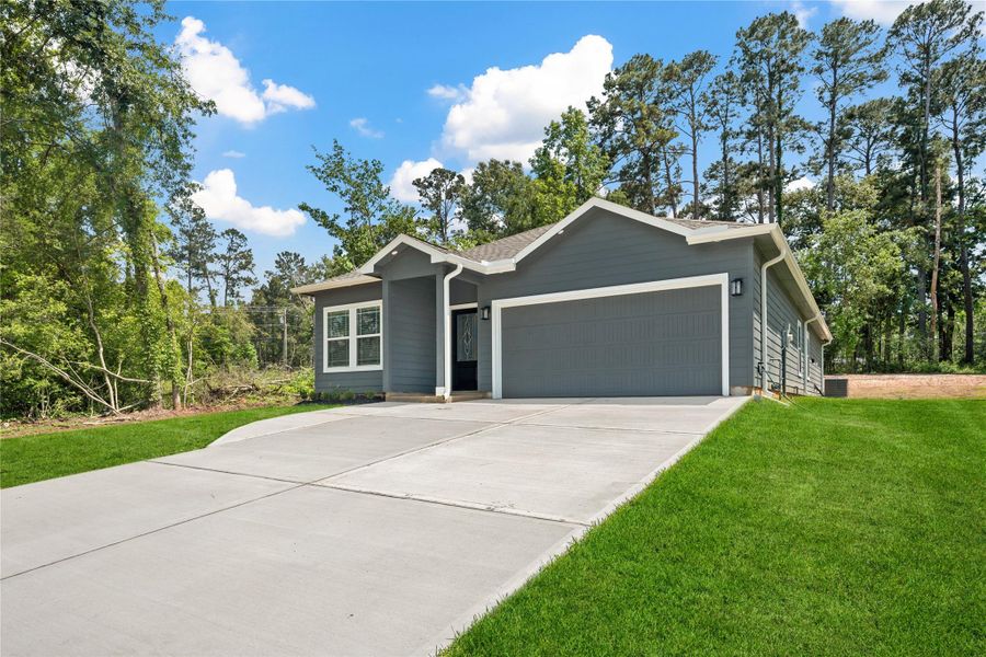 Front exterior of a new home in , Onalaska, TX, highlighting curb appeal (Image 1).