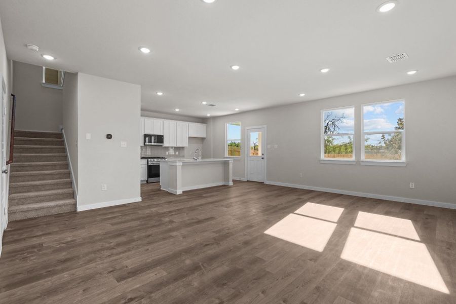 A large kitchen with white cabinets. A large kitchen with white cabinets.