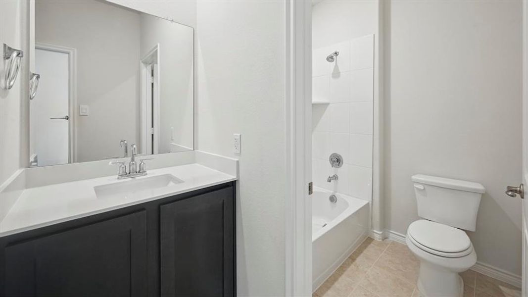 Full bathroom with vanity, bathing tub / shower combination, and light tile patterned floors