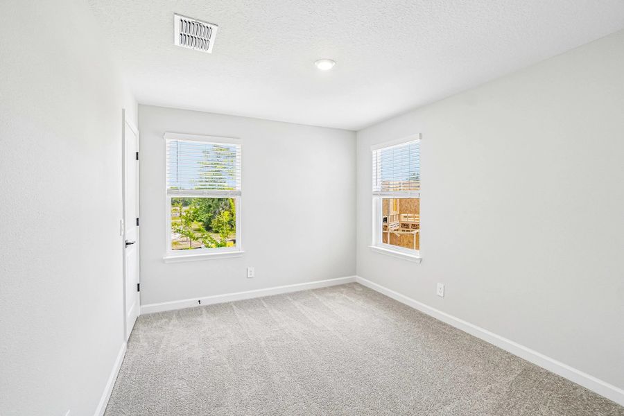 Bedroom 2 is located off the front of the home and features a walk-in closet Bedroom 2 is located off the front of the home and features a walk-in closet