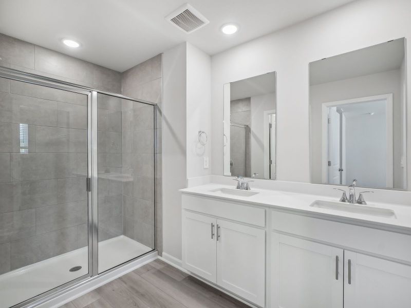 The luxurious primary suite features an ensuite bath with dual sinks and a walk-in closet.