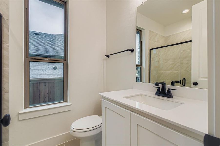 Bathroom featuring vanity, a shower stall, tile patterned flooring, healthy amount of natural light, and recessed lighting Bathroom featuring vanity, a shower stall, tile patterned flooring, healthy amount of natural light, and recessed lighting