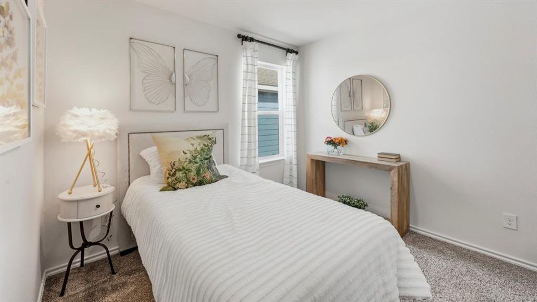 Carpeted bedroom featuring baseboards