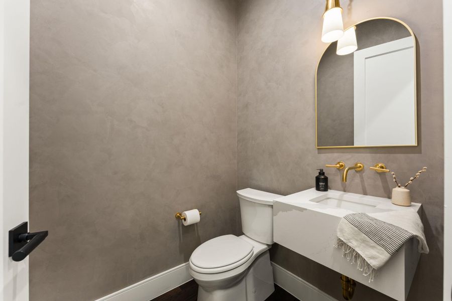 Half bathroom located on the first floor with plaster walls.