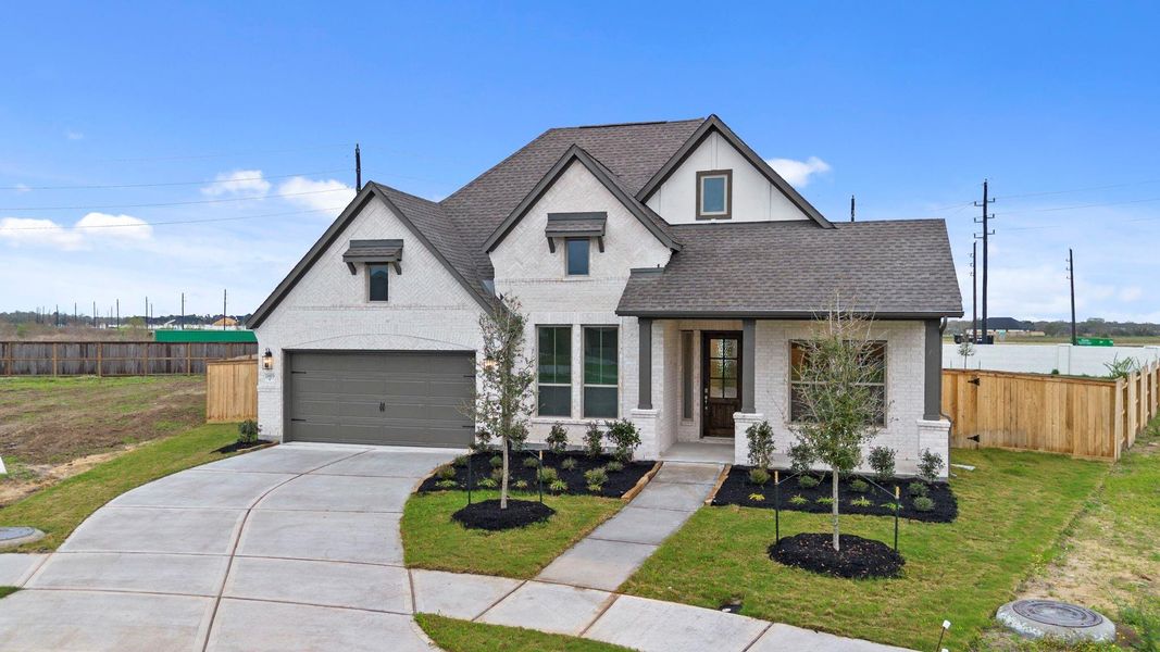 Front exterior of a new home in Valencia, Manvel, TX, highlighting curb appeal (Image 24).