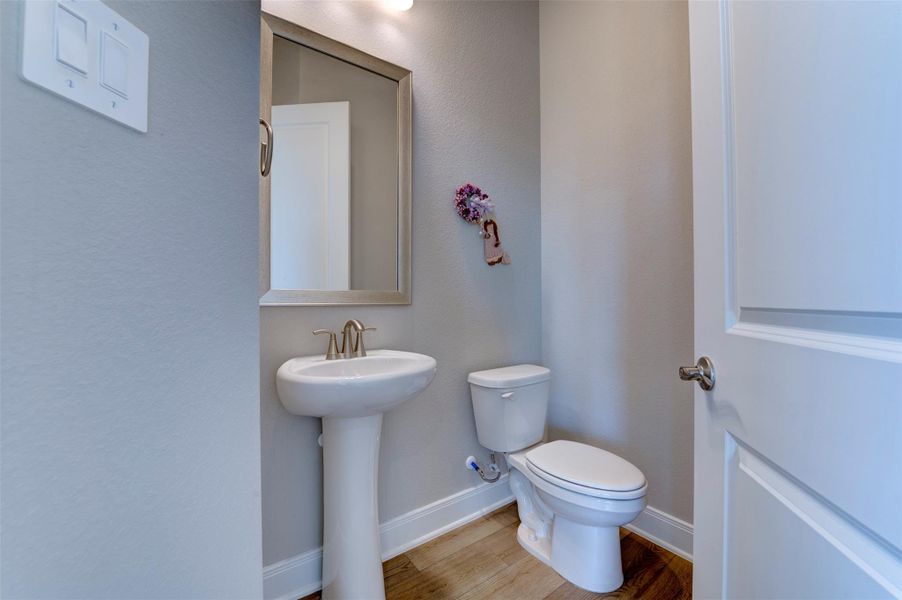 Convenient downstairs half bath with modern fixtures and clean finishes.