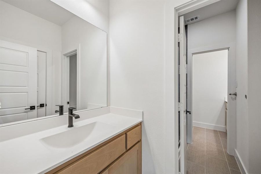 Bathroom with vanity and baseboards