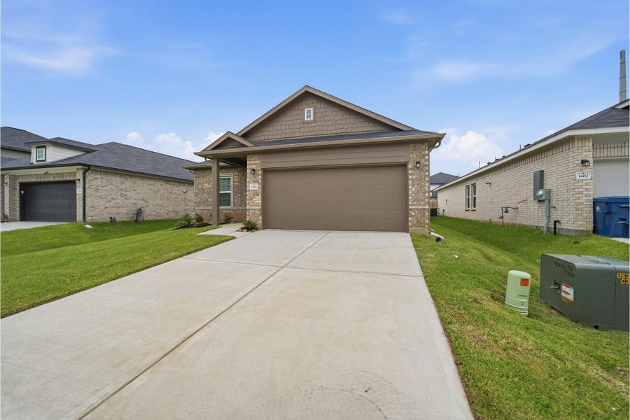 Front exterior of a new home in Steed Landing, Texas City, TX, highlighting curb appeal (Image 14). Front exterior of a new home in Steed Landing, Texas City, TX, highlighting curb appeal (Image 14).