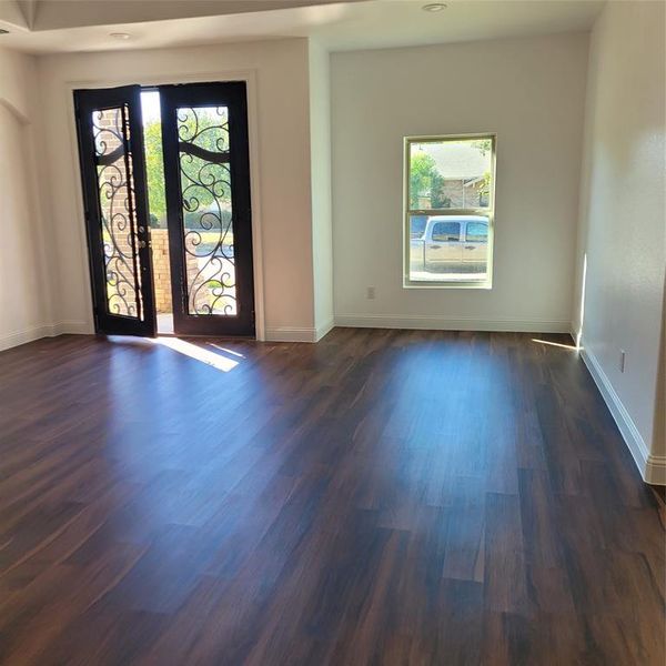 Spare room with dark hardwood / wood-style floors