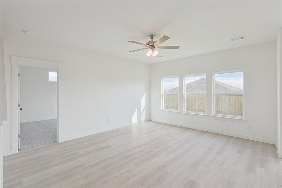 Unfurnished room featuring ceiling fan and light hardwood / wood-style floors