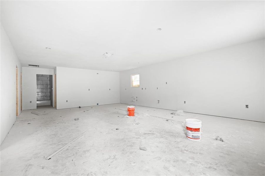 The property features an open area with white walls and a visible window