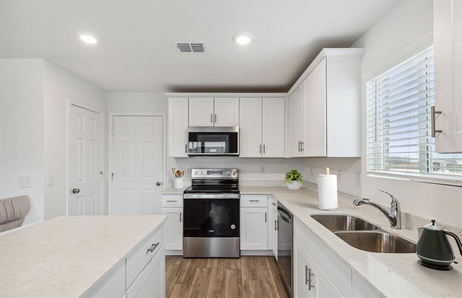 Bright kitchen with ample cabinet space *Photos of furnished model. Not actual home. Representative of floor plan. Some options and features may vary