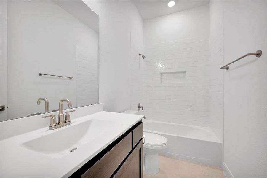 Full bathroom featuring vanity, shower combination, light tile patterned flooring, and recessed lighting Full bathroom featuring vanity, shower combination, light tile patterned flooring, and recessed lighting