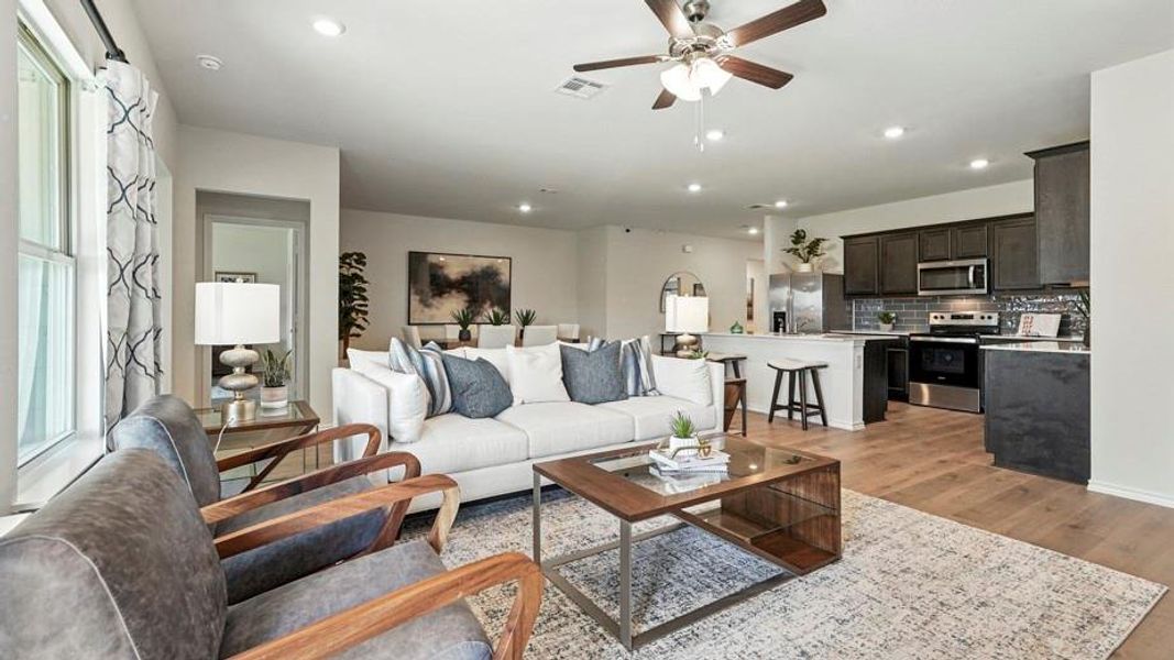 Living room with ceiling fan, light wood-style flooring, and recessed lighting Living room with ceiling fan, light wood-style flooring, and recessed lighting